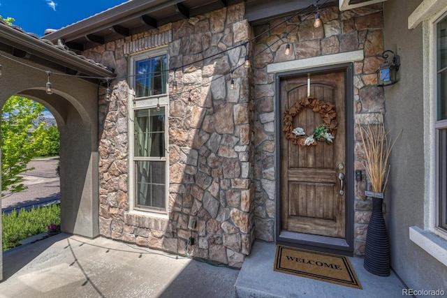 15235 W Iliff Ave, Lakewood, CO 80228 - doorway to property featuring stone siding