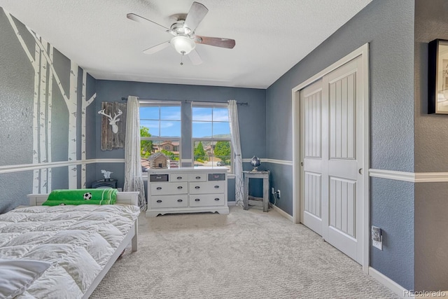 15235 W Iliff Ave, Lakewood, CO 80228 - bedroom with a textured wall, a textured ceiling, carpet flooring, ceiling fan, and a closet