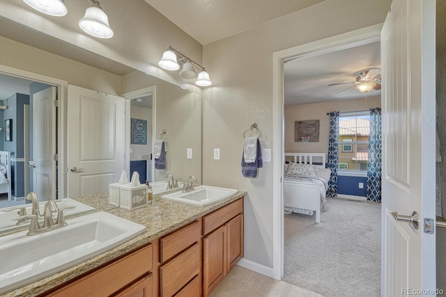 15235 W Iliff Ave, Lakewood, CO 80228 - ensuite bathroom featuring double vanity, baseboards, and ceiling fan