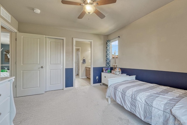 15235 W Iliff Ave, Lakewood, CO 80228 - bedroom featuring light carpet, connected bathroom, ceiling fan, and baseboards