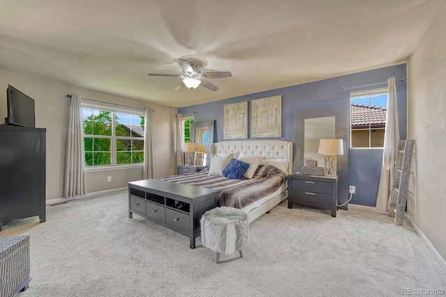 15235 W Iliff Ave, Lakewood, CO 80228 - bedroom with multiple windows, light carpet, baseboards, and ceiling fan