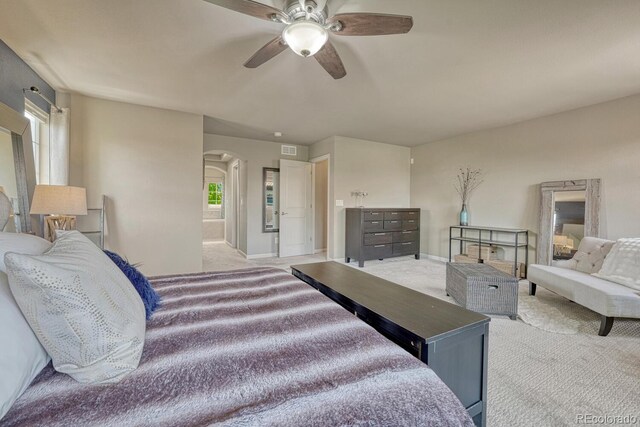 15235 W Iliff Ave, Lakewood, CO 80228 - bedroom with light carpet, arched walkways, a ceiling fan, and baseboards