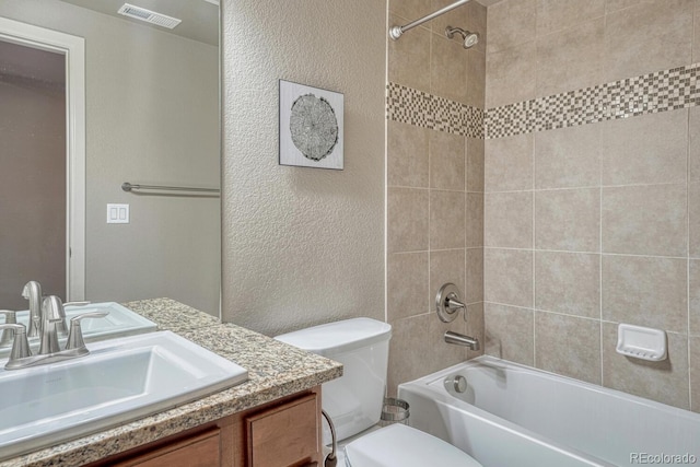15235 W Iliff Ave, Lakewood, CO 80228 - bathroom with toilet, vanity, washtub / shower combination, and a textured wall
