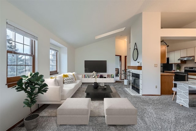 1661 S Fulton St, Aurora, CO 80247 - carpeted living area featuring a fireplace with flush hearth and high vaulted ceiling