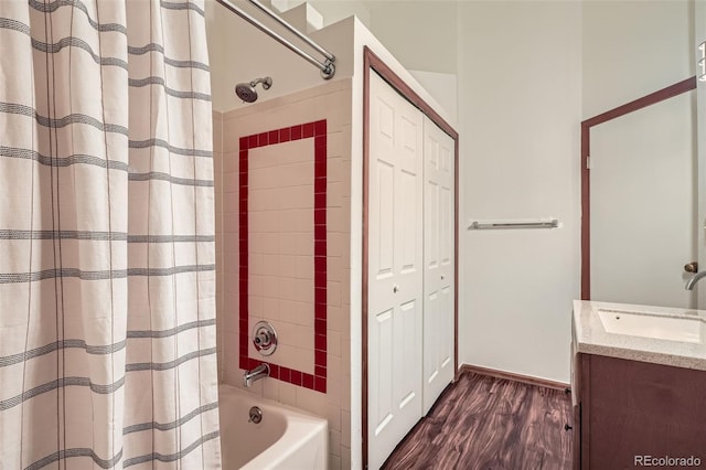 1661 S Fulton St, Aurora, CO 80247 - bathroom with vanity, shower / bathtub combination with curtain, wood finished floors, and a closet