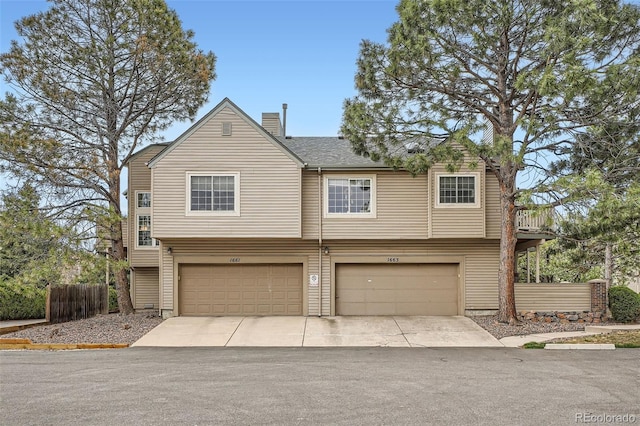 1661 S Fulton St, Aurora, CO 80247 - view of front of home featuring an attached garage, driveway, and a chimney