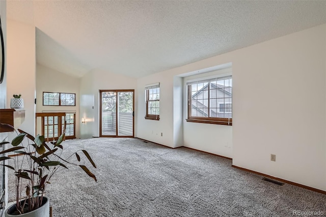 1661 S Fulton St, Aurora, CO 80247 - living room with carpet flooring, baseboards, a textured ceiling, and vaulted ceiling