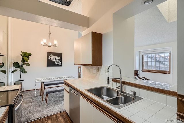 1661 S Fulton St, Aurora, CO 80247 - kitchen with tile counters, a sink, dark wood-style floors, and appliances with stainless steel finishes