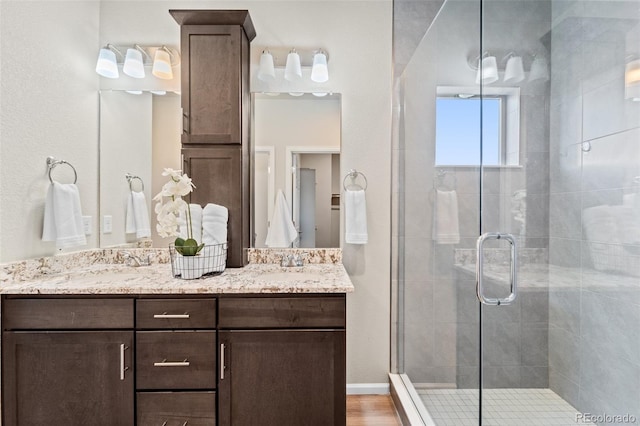 bathroom with vanity, hardwood / wood-style floors, and an enclosed shower