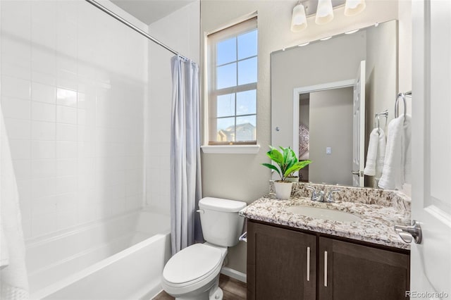 full bathroom featuring vanity, shower / bath combo with shower curtain, and toilet