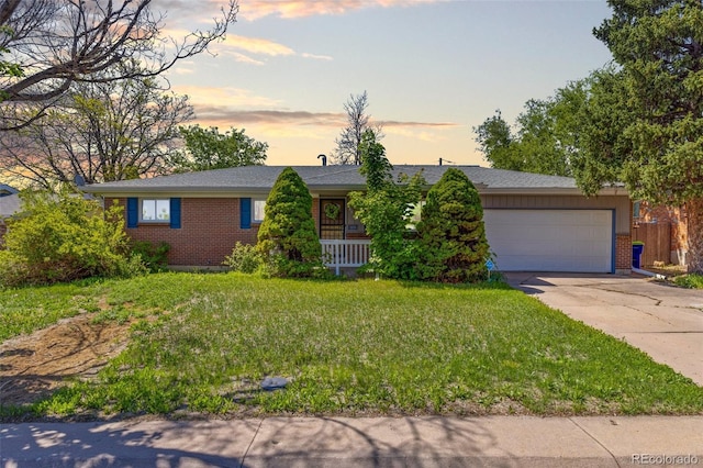 430 S Potomac Cir, Aurora, CO 80012 - ranch-style house with brick siding, a garage, driveway, and a front lawn