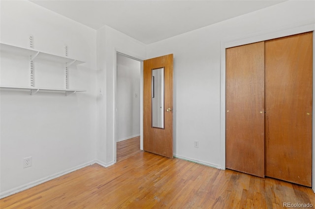 430 S Potomac Cir, Aurora, CO 80012 - unfurnished bedroom with wood finished floors, a closet, and baseboards