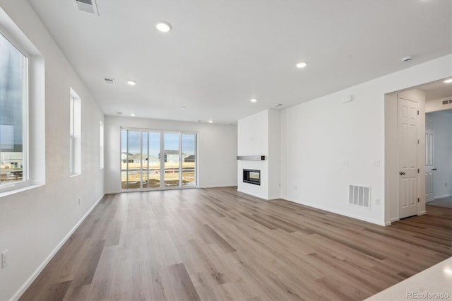 unfurnished living room with light hardwood / wood-style floors