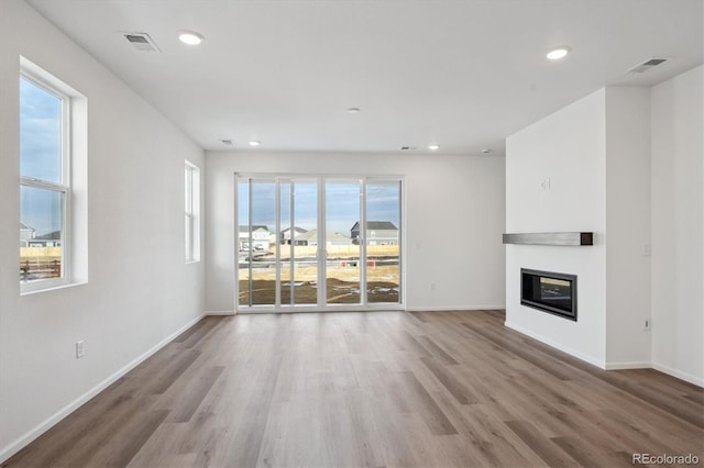 unfurnished living room with hardwood / wood-style flooring