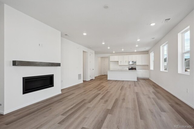 unfurnished living room with light wood-type flooring