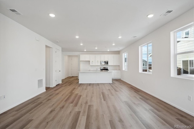 unfurnished living room featuring light wood-type flooring