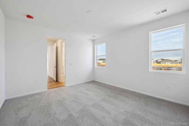 empty room with light colored carpet