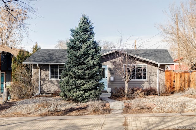 ranch-style house featuring fence