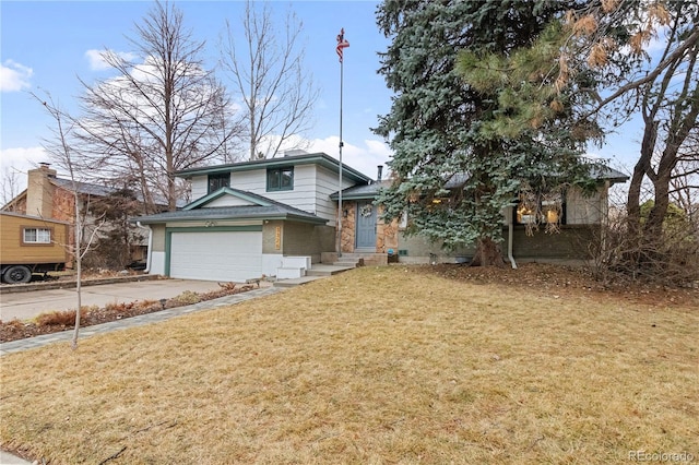 split level home with a front yard, brick siding, and driveway