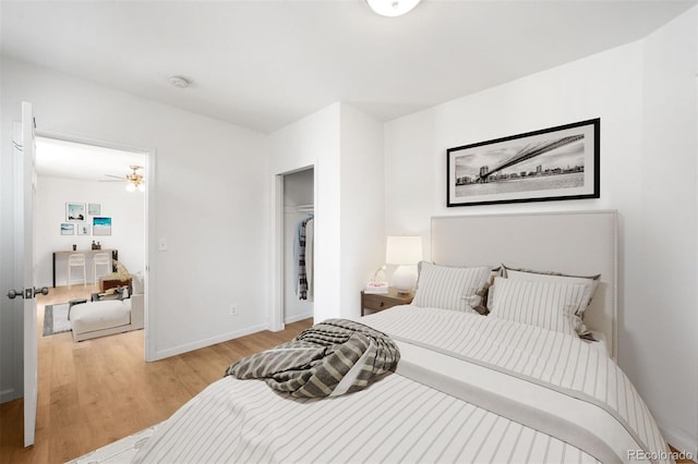 215 E 11th Ave Unit D5, Denver, CO 80203 - bedroom with light wood-style flooring, baseboards, and a closet