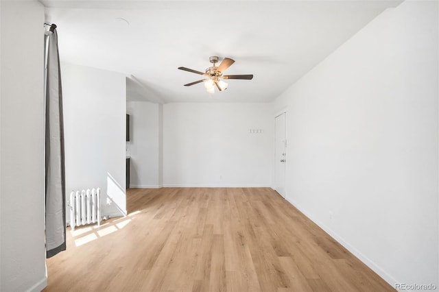 215 E 11th Ave Unit D5, Denver, CO 80203 - spare room featuring radiator heating unit, light wood-style floors, a ceiling fan, and baseboards