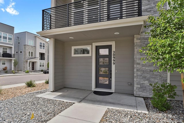20999 E Quincy Dr, Aurora, CO 80015 - view of exterior entry with a balcony and stone siding