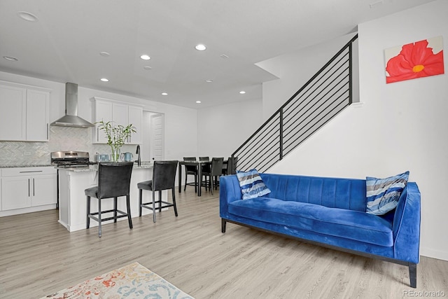 20999 E Quincy Dr, Aurora, CO 80015 - living area featuring light wood-type flooring, recessed lighting, and stairway