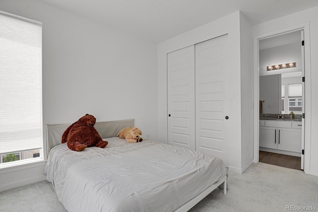 20999 E Quincy Dr, Aurora, CO 80015 - carpeted bedroom with a closet, baseboards, and ensuite bath