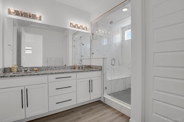 20999 E Quincy Dr, Aurora, CO 80015 - bathroom with double vanity, a marble finish shower, and wood finished floors
