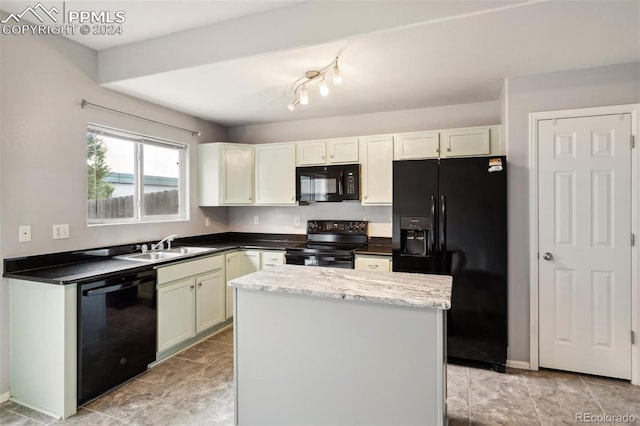 kitchen featuring light stone counters, sink, black appliances, white cabinets, and a center island