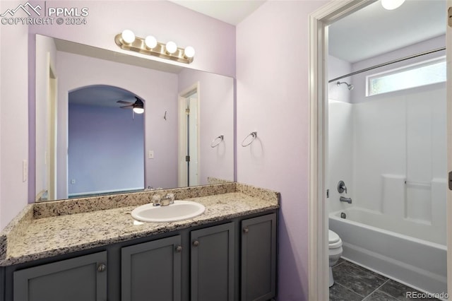 full bathroom with vanity, shower / washtub combination, tile patterned flooring, ceiling fan, and toilet