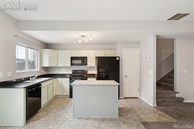 kitchen with sink, a center island, white cabinetry, and black appliances