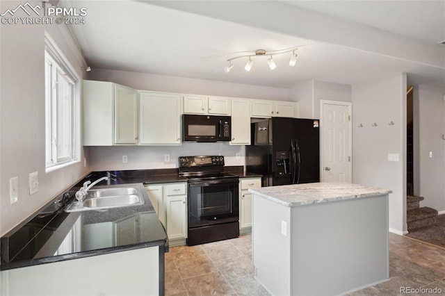 kitchen featuring a center island, black appliances, white cabinets, sink, and a healthy amount of sunlight