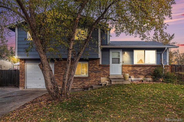 view of front facade featuring a garage and a yard