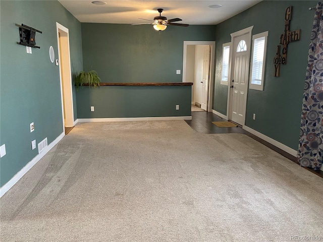 entrance foyer with carpet and ceiling fan