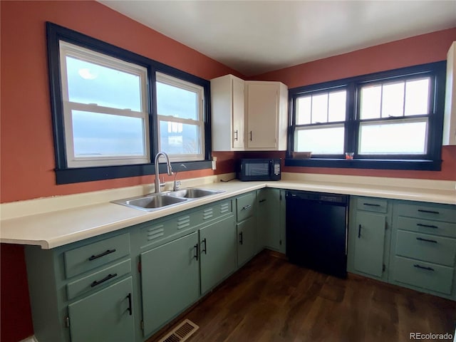 kitchen with black appliances, green cabinets, dark hardwood / wood-style flooring, and sink