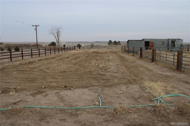 view of yard with a rural view and an outdoor structure