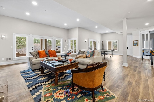 living area featuring recessed lighting, wood finished floors, visible vents, and baseboards
