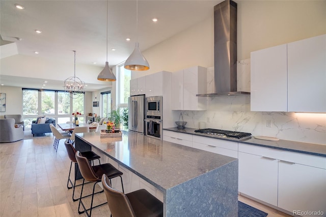 5125 W 29th Ave Unit 1, Denver, CO 80212 - kitchen with modern cabinets, appliances with stainless steel finishes, wall chimney exhaust hood, recessed lighting, and backsplash