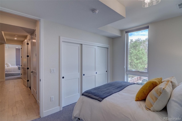 5125 W 29th Ave Unit 1, Denver, CO 80212 - bedroom featuring baseboards, multiple windows, a closet, and wood finished floors