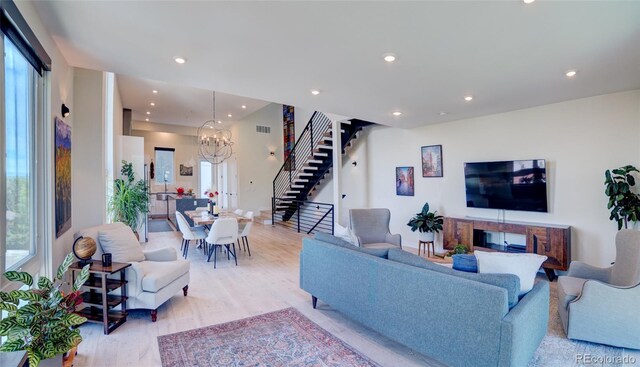 5125 W 29th Ave Unit 1, Denver, CO 80212 - living room featuring stairway, healthy amount of natural light, light wood-style floors, recessed lighting, and a chandelier
