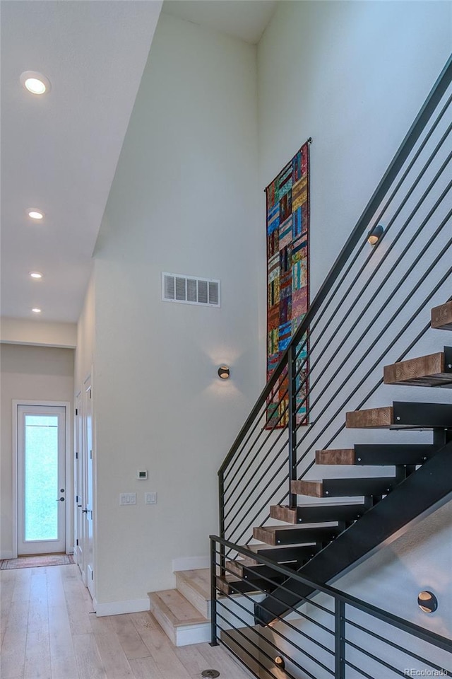 5125 W 29th Ave Unit 1, Denver, CO 80212 - stairs with wood finished floors, baseboards, recessed lighting, and a towering ceiling