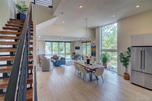 5125 W 29th Ave Unit 1, Denver, CO 80212 - dining room with stairway, recessed lighting, light wood-style flooring, a chandelier, and a high ceiling