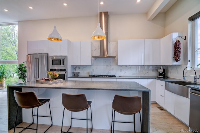 5125 W 29th Ave Unit 1, Denver, CO 80212 - kitchen with appliances with stainless steel finishes, a sink, modern cabinets, decorative backsplash, and healthy amount of natural light