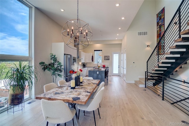 5125 W 29th Ave Unit 1, Denver, CO 80212 - dining room with a high ceiling, stairs, light wood-type flooring, a chandelier, and recessed lighting