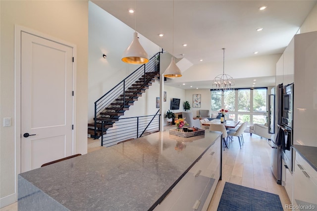 5125 W 29th Ave Unit 1, Denver, CO 80212 - kitchen featuring white cabinetry, modern cabinets, recessed lighting, open floor plan, and light wood-style flooring