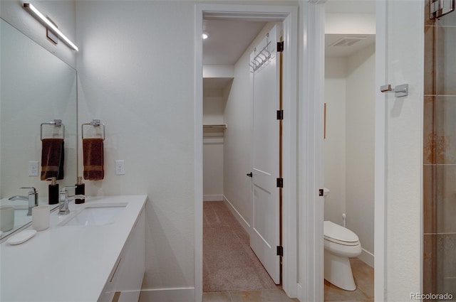 5125 W 29th Ave Unit 1, Denver, CO 80212 - bathroom with toilet, vanity, a walk in closet, and baseboards