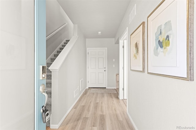 hallway with light hardwood / wood-style flooring