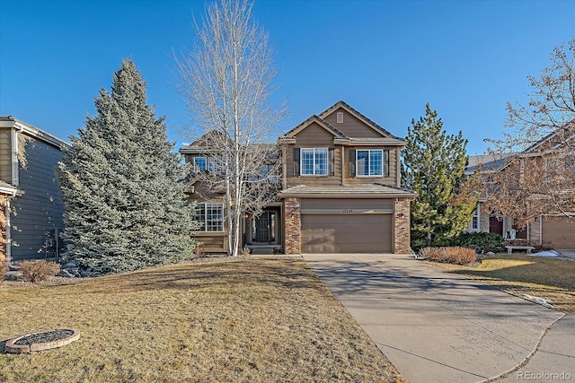 traditional home with a garage, a front lawn, concrete driveway, and brick siding