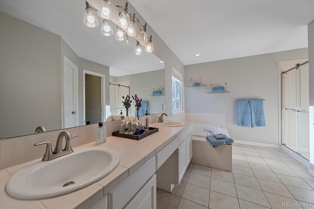 bathroom with a stall shower, a sink, a bath, and tile patterned floors